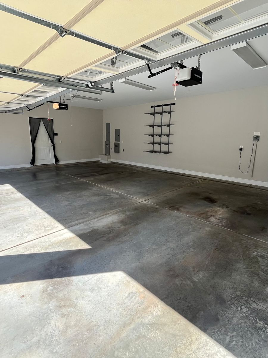 In progress: the garage emptied out with a bare concrete floor