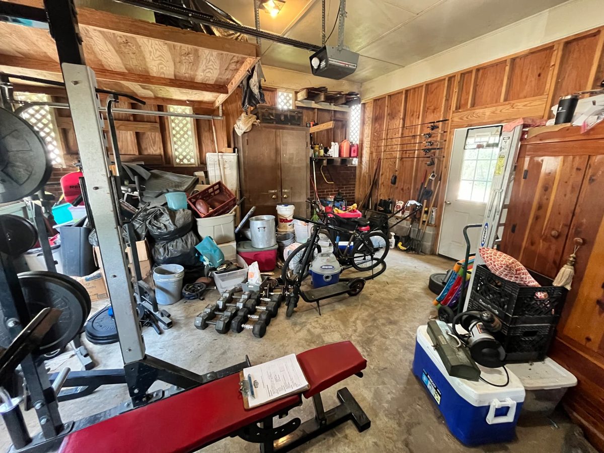 Before: garage crowded with bags, bins, buckets, dumbbells, a bike, coolers, and exercise equipment across the floor