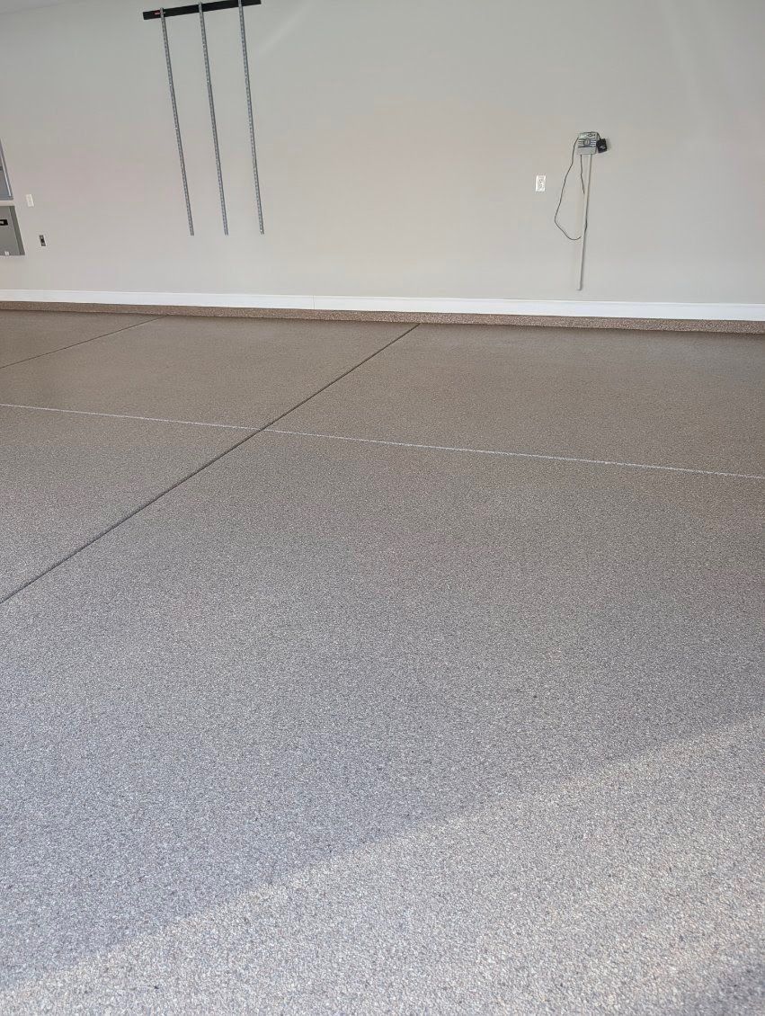 After: close-up of the finished speckled epoxy floor along the painted wall